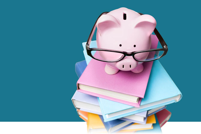 Piggy bank wearing glasses on stack of books