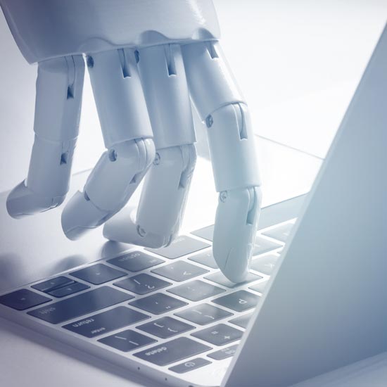 Building-the-foundation-FEATURE -- Machine hand typing on a laptop.